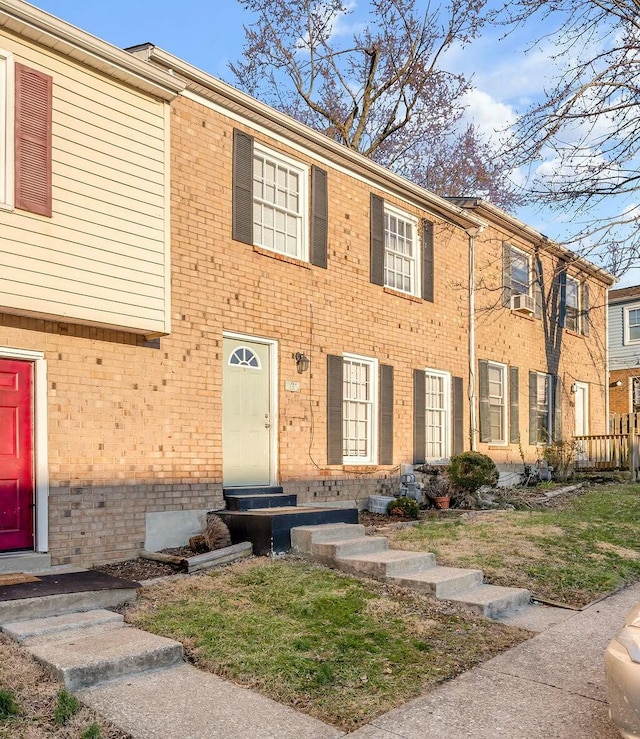 townhome / multi-family property with entry steps and brick siding