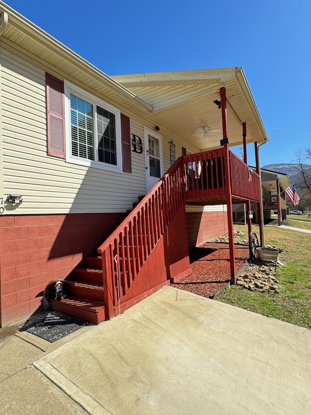 exterior space with a ceiling fan, a patio, and stairs