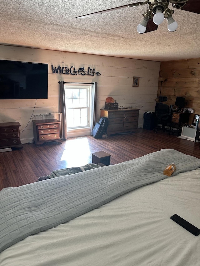 bedroom with a textured ceiling and dark wood-type flooring