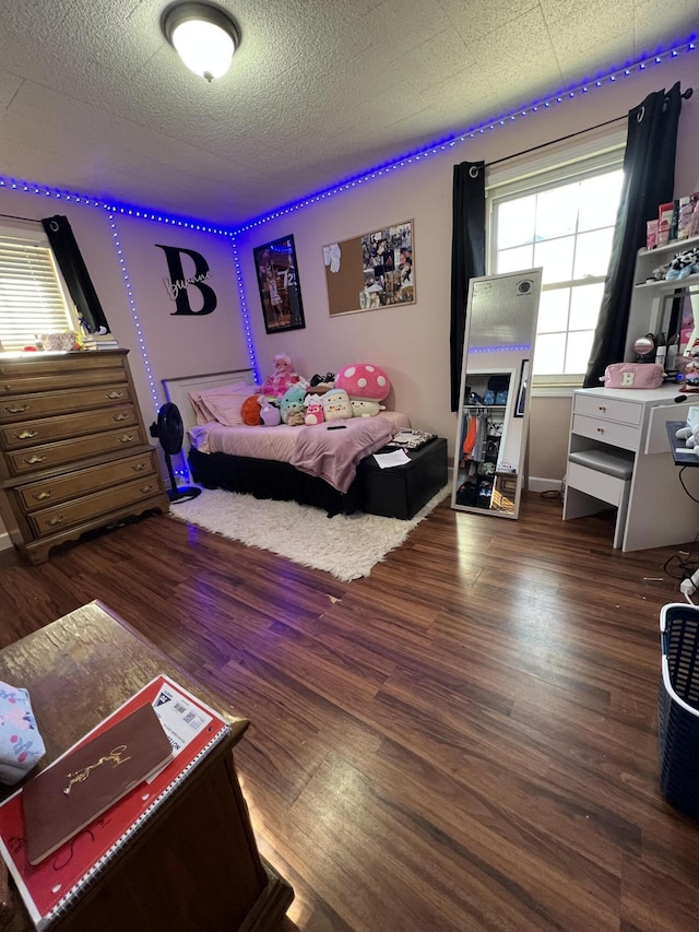 bedroom featuring dark wood-style flooring and a textured ceiling