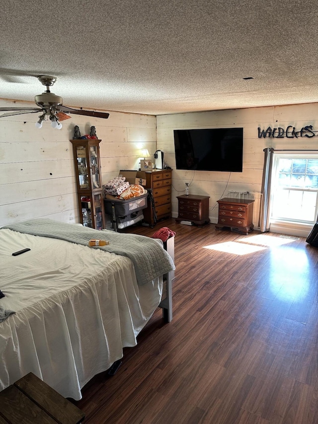 bedroom with a textured ceiling and dark wood-style flooring