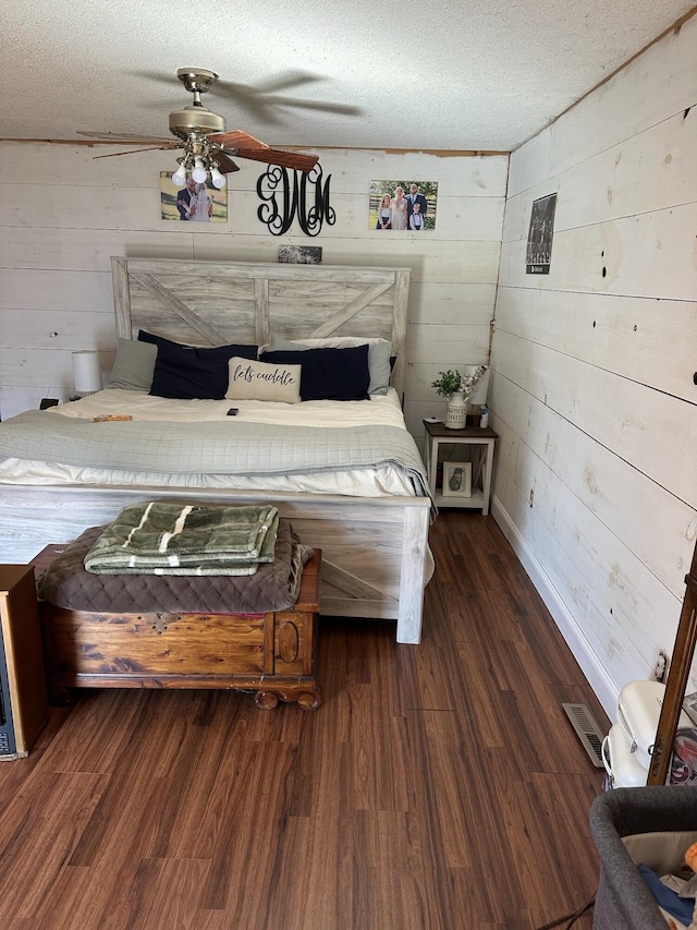 unfurnished bedroom featuring a textured ceiling, dark wood-type flooring, and visible vents