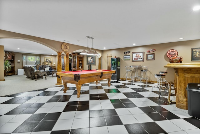 rec room featuring arched walkways, recessed lighting, baseboards, a bar, and ornate columns