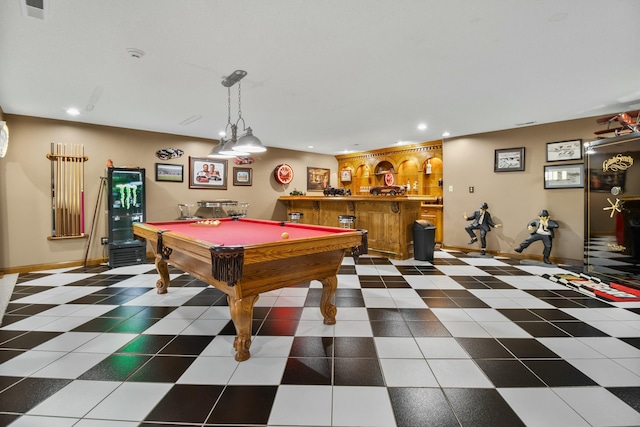 game room with recessed lighting, bar area, dark tile patterned flooring, and baseboards