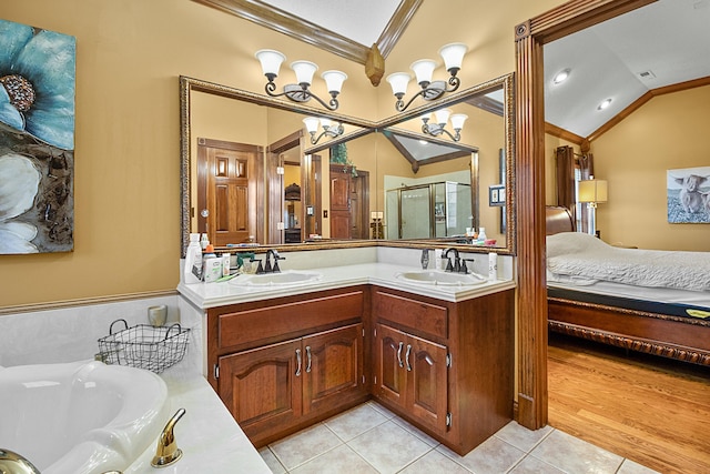 bathroom featuring lofted ceiling, a sink, and crown molding