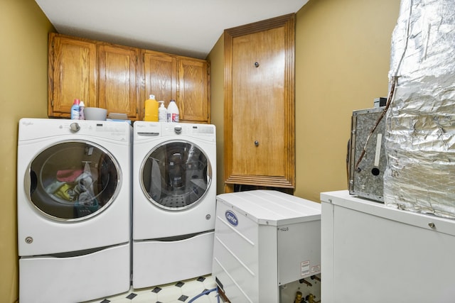 laundry room featuring washer and dryer, cabinet space, and tile patterned floors