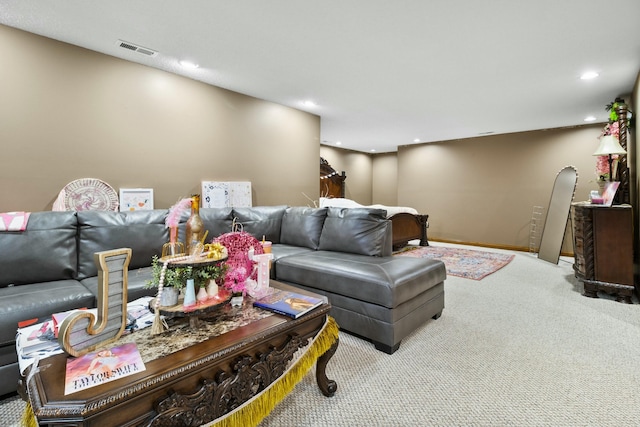 carpeted living area with recessed lighting, visible vents, and baseboards