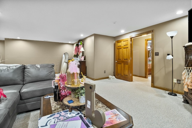 living area with recessed lighting, light colored carpet, and baseboards