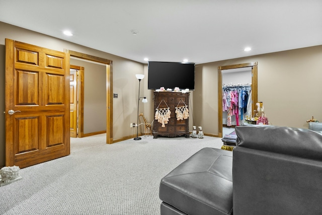 living area with carpet, baseboards, and recessed lighting