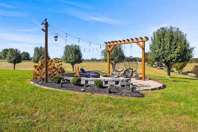 view of yard with an outdoor fire pit and a rural view