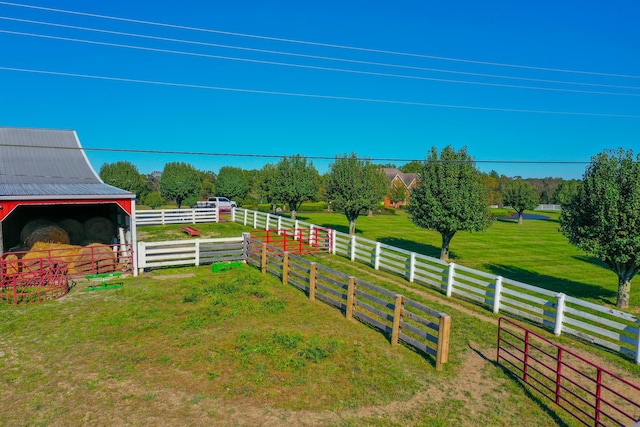 view of yard featuring an outbuilding and a rural view