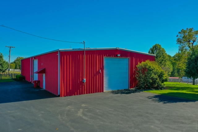 view of outdoor structure with an outbuilding and fence