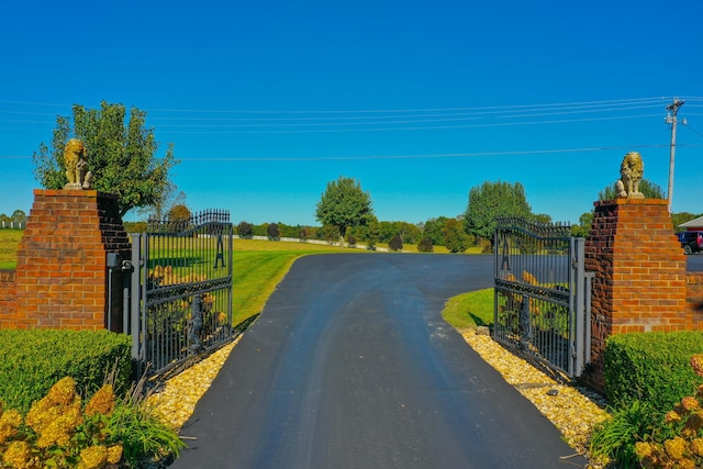 view of road featuring a gate and a gated entry