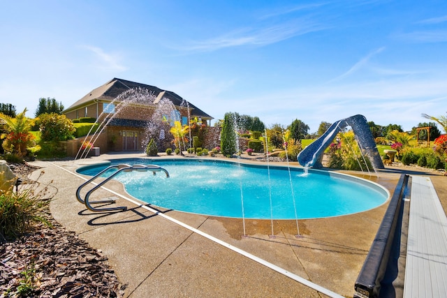 pool with a patio and a water slide