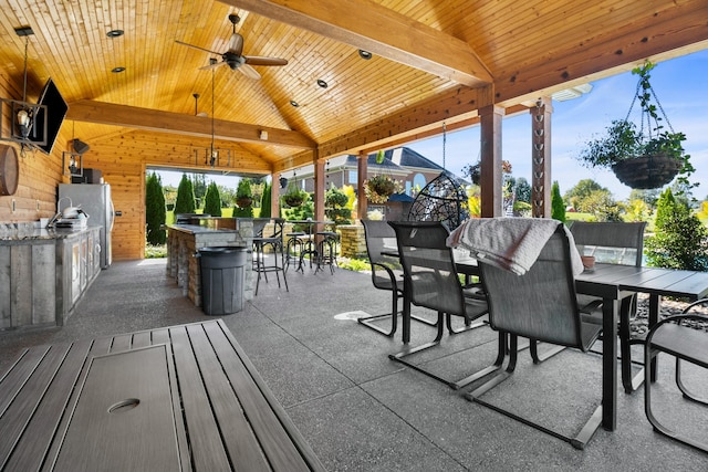 view of patio / terrace with ceiling fan, outdoor dining area, area for grilling, and outdoor wet bar