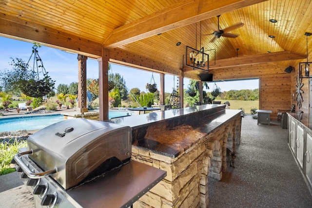 view of patio featuring area for grilling, an outdoor pool, a ceiling fan, and outdoor wet bar