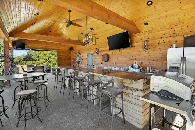 view of patio featuring ceiling fan, area for grilling, a sink, and outdoor wet bar