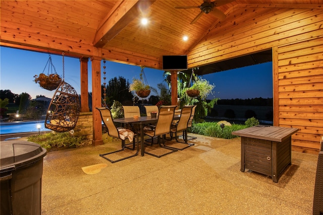 view of patio / terrace with an outdoor pool, a ceiling fan, and outdoor dining space