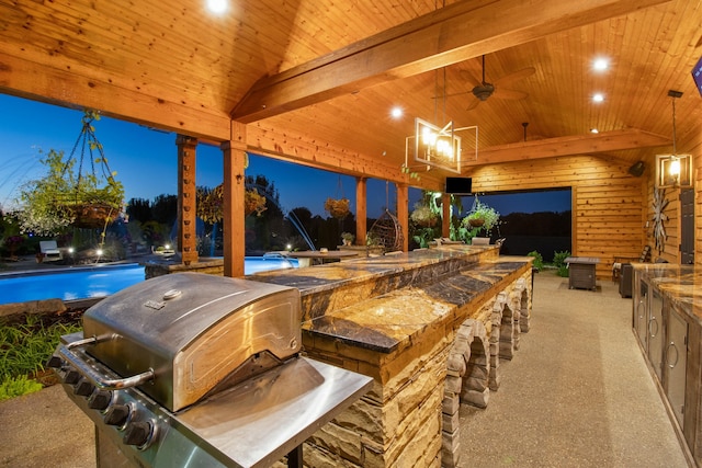 view of patio with area for grilling, a grill, ceiling fan, outdoor wet bar, and an outdoor pool