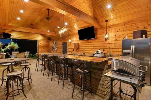 bar with vaulted ceiling with beams, wooden ceiling, wet bar, and decorative light fixtures