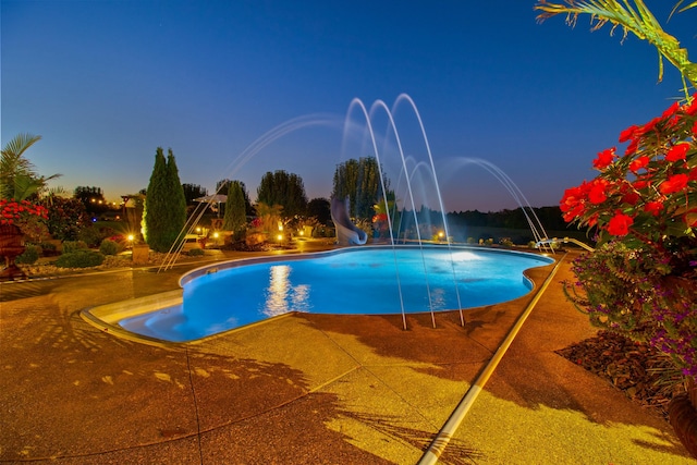 outdoor pool featuring a water slide