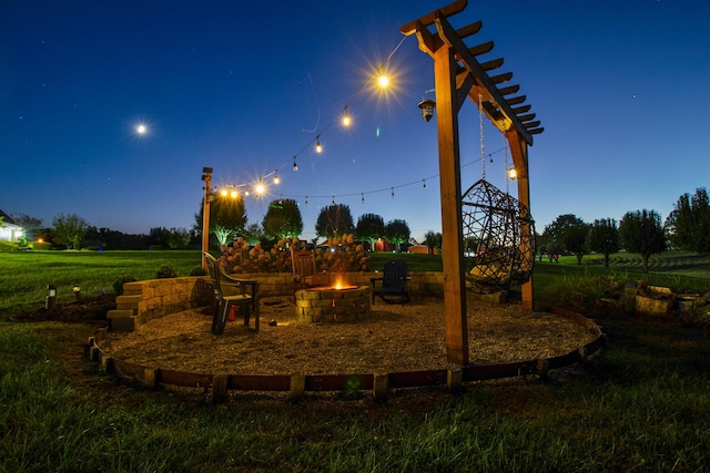 view of play area with an outdoor fire pit and a yard