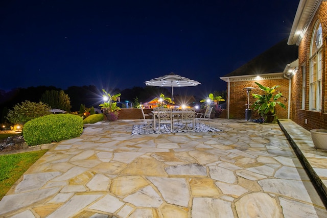 patio at twilight featuring outdoor dining space