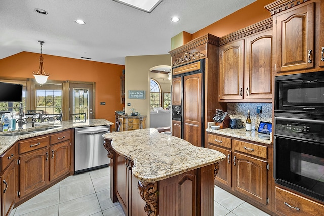 kitchen with a center island, brown cabinets, decorative light fixtures, light tile patterned floors, and black appliances