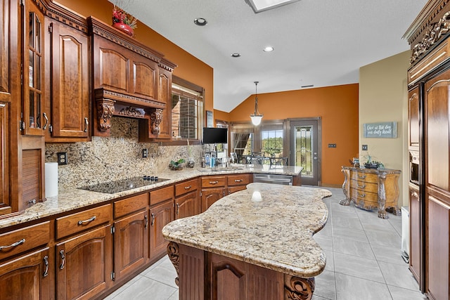 kitchen with a kitchen island, glass insert cabinets, black electric stovetop, pendant lighting, and backsplash