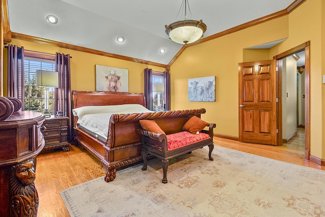 bedroom featuring lofted ceiling, ornamental molding, light wood-type flooring, and baseboards