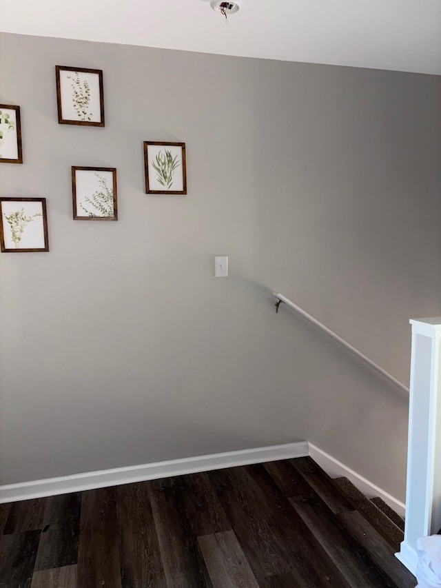 stairway featuring baseboards and wood finished floors