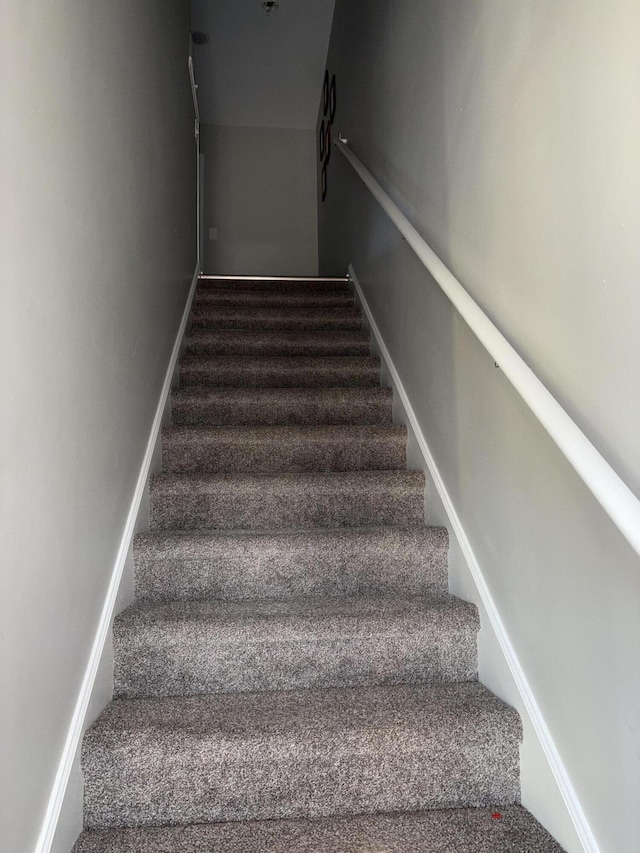 staircase with carpet and baseboards