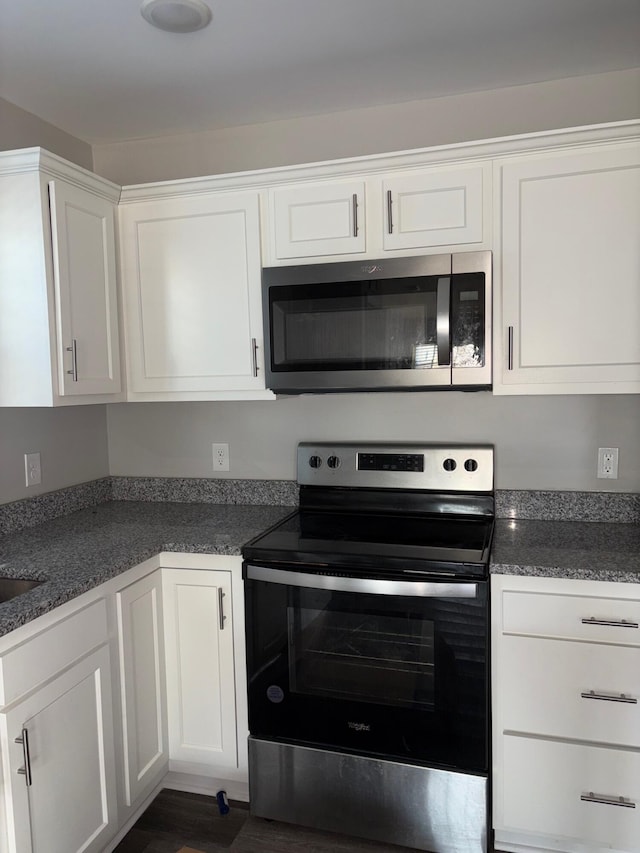 kitchen featuring stainless steel appliances and white cabinetry