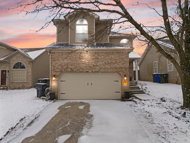 view of front of house with brick siding and an attached garage