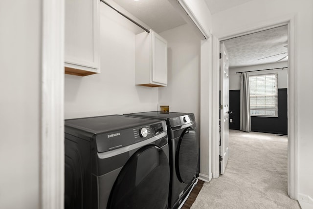 laundry room with baseboards, carpet flooring, cabinet space, and washer and dryer