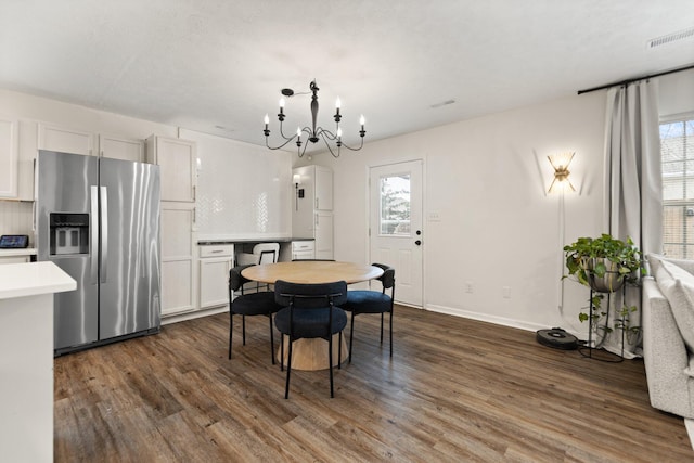 dining space featuring dark wood finished floors, visible vents, plenty of natural light, and baseboards