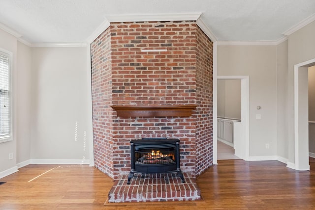 unfurnished living room with a fireplace, crown molding, a textured ceiling, and wood finished floors