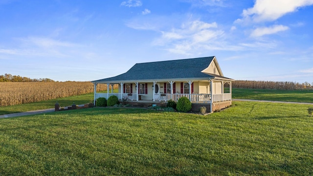 farmhouse inspired home with a porch, a front yard, and a shingled roof