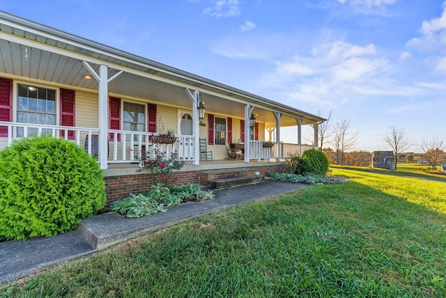 view of front of home with covered porch and a front yard