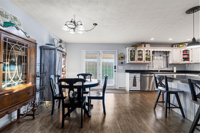 dining space featuring dark wood-style floors, recessed lighting, a textured ceiling, and an inviting chandelier