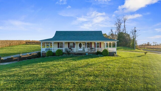 farmhouse inspired home with a porch and a front yard