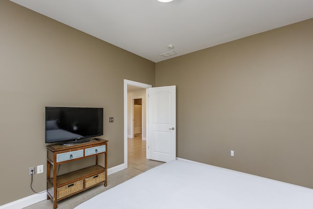 bedroom with visible vents, baseboards, and light tile patterned floors