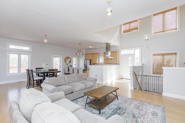 living room with light wood-type flooring and baseboards