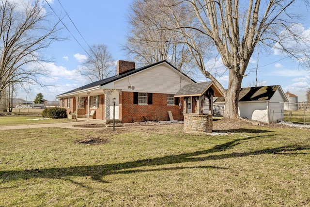 exterior space featuring a porch, a chimney, a front lawn, and brick siding