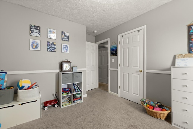 game room with carpet and a textured ceiling