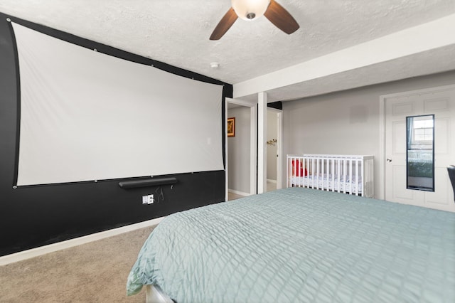 bedroom featuring carpet flooring, ceiling fan, a textured ceiling, and baseboards