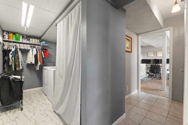 interior space with baseboards and washing machine and clothes dryer