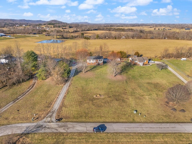 drone / aerial view featuring a rural view and a water and mountain view