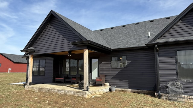 back of house with a patio area and a shingled roof