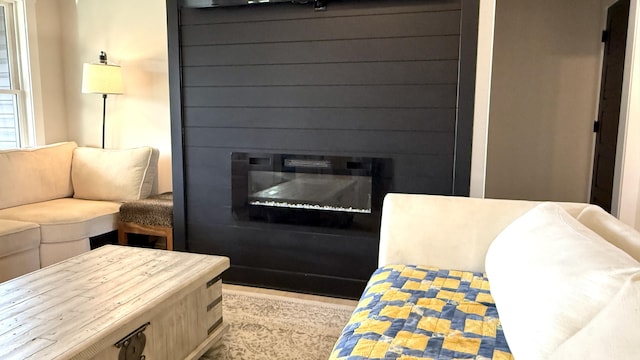 living area featuring a glass covered fireplace